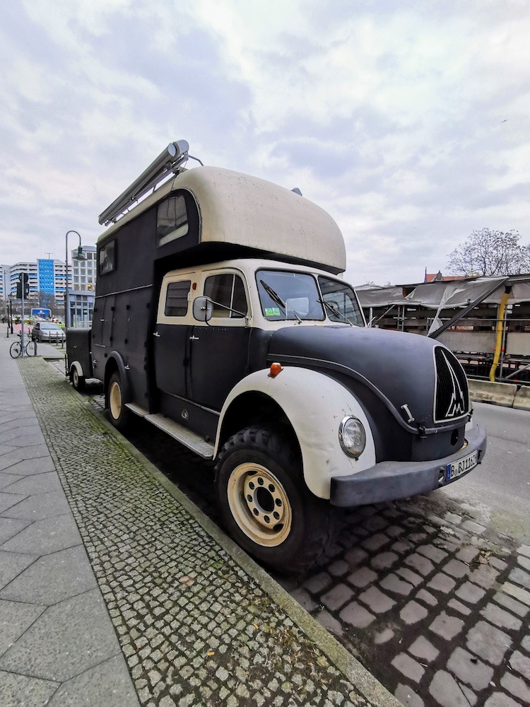 An old german truck parked on the street.