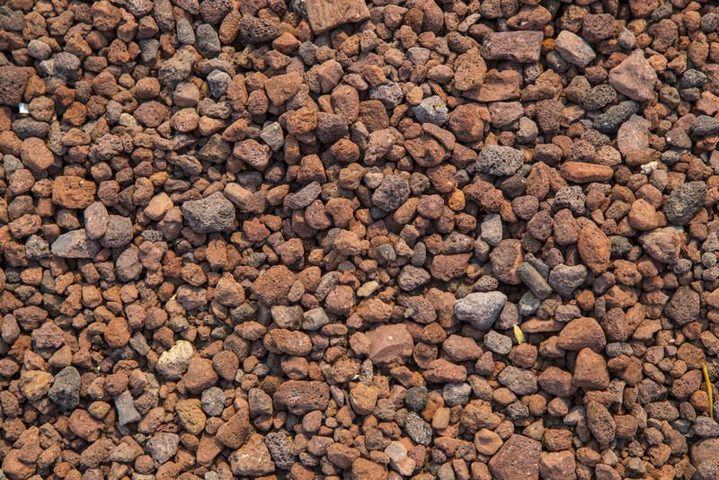 Small volcanic/lava rock/gravel in bordeaux and brown color tones.